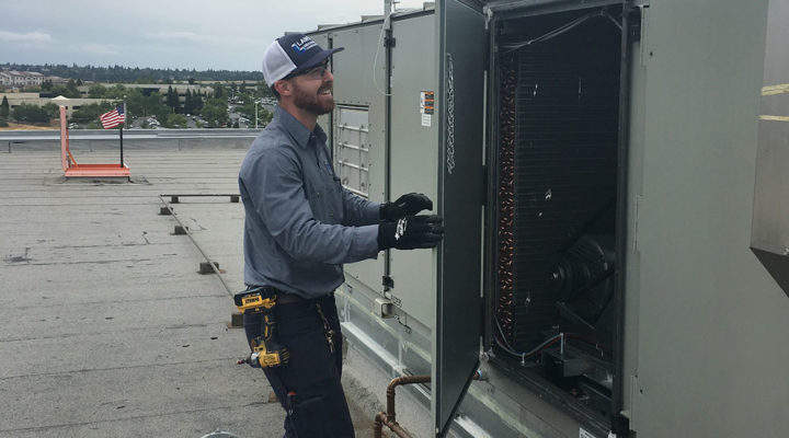 Employee-working-on-industrial-systems Repairing industrial HVAC systems